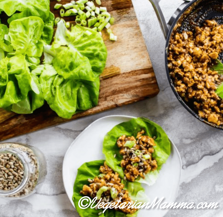 Thai lettuce wraps, skillet of mixture and cutting board of ingredients