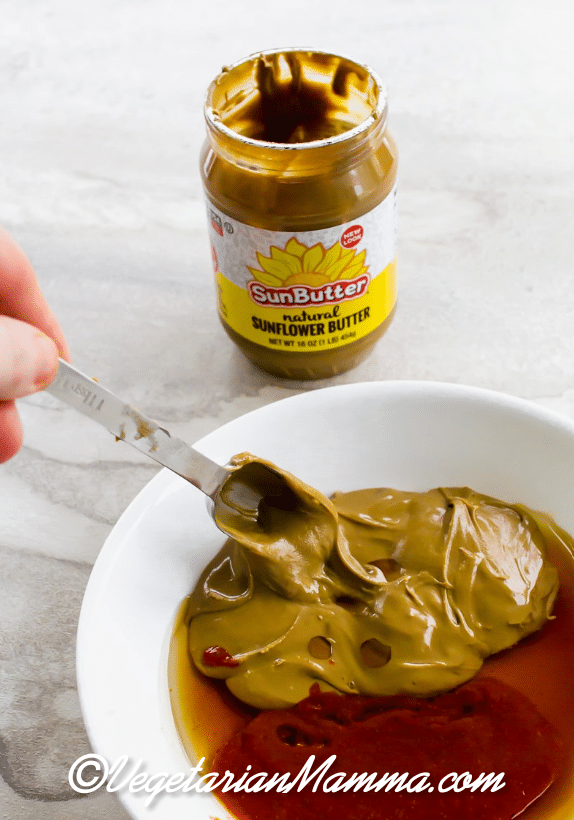 Thai lettuce wrap sauce mixture in a bowl and a jar of sunbutter