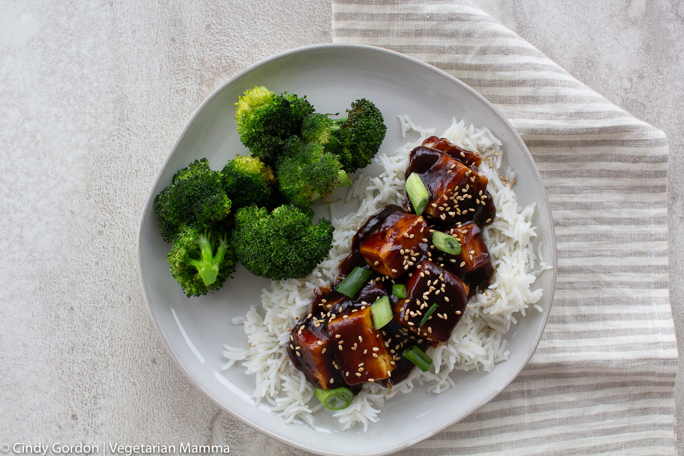 Saucy General Tso Tofu served with broccoli over rice