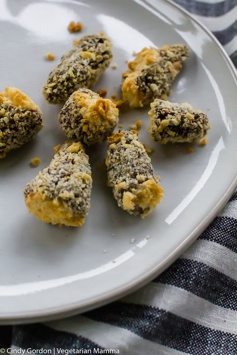 Air Fryer Morel Mushrooms on white plate with a black and white striped napkin on the right