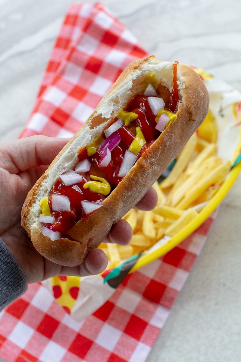 air fried hot dog in bun with fixings on top