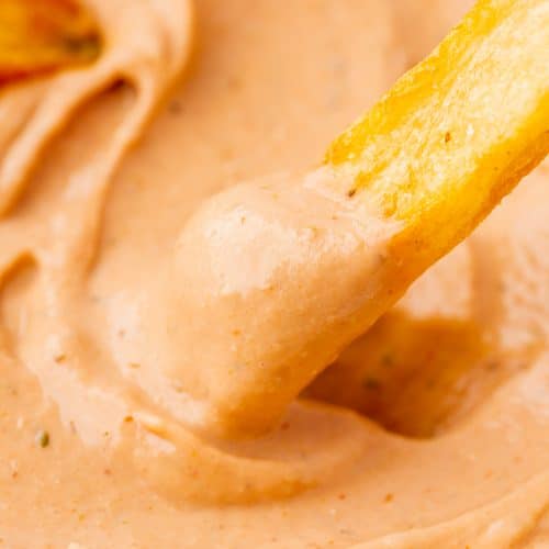 a french fry dipping into creamy bbq ranch