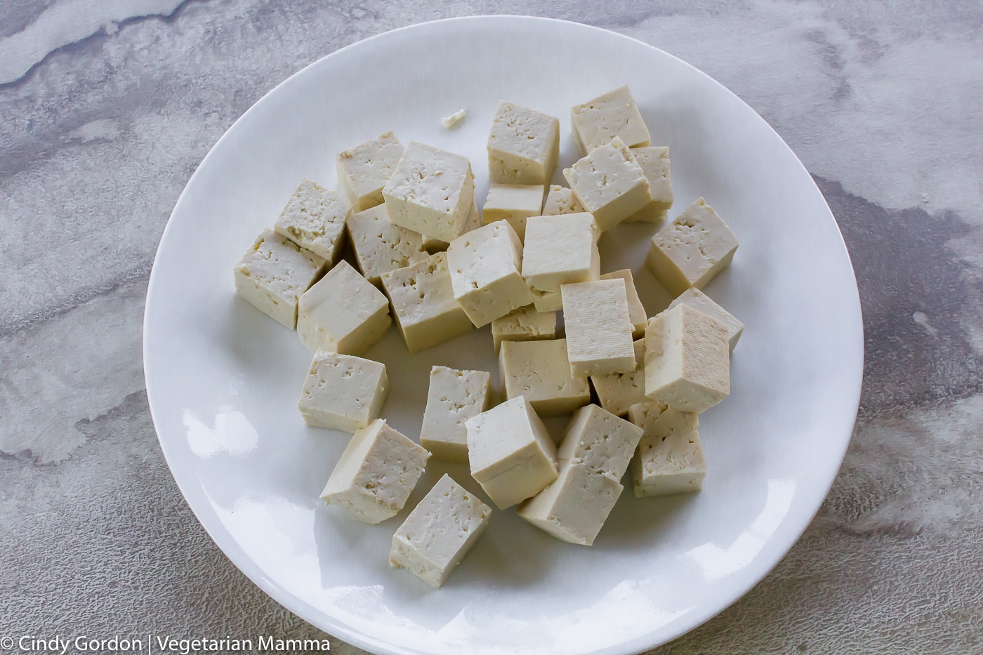 tofu cubes on a white plate