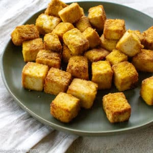 Crispy tofu served on a green plate