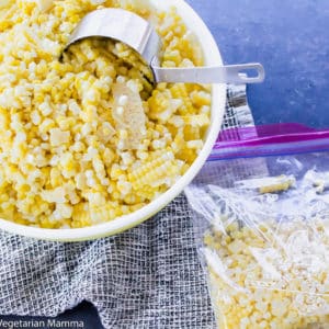 Corn in a round white bowl with a black and white cloth underneath