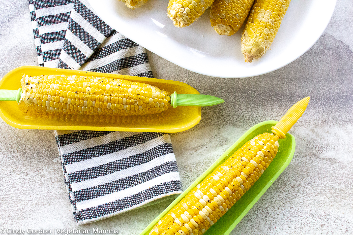 cooked corn on plates with butter