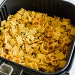 Air Fryer Chex Mix cooked in air fryer basket