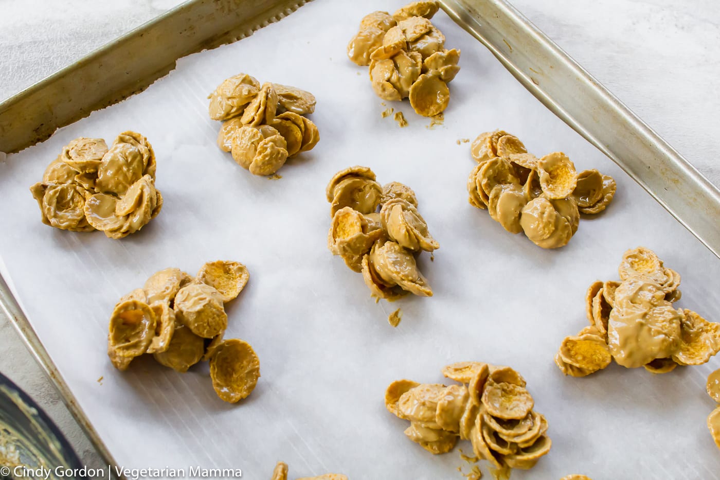 Cornflake cookies without sprinkles on parchment paper