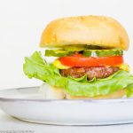 air fryer hamburger on a white plate with a white background