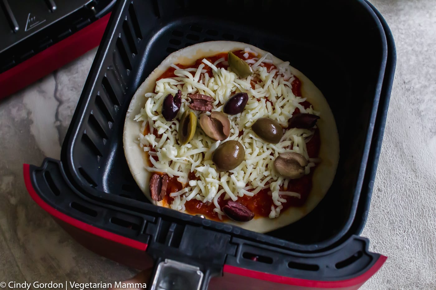 uncooked pizza in an air fryer