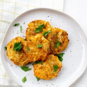 Leftover mashed potato pancakes on a white plate with a white background