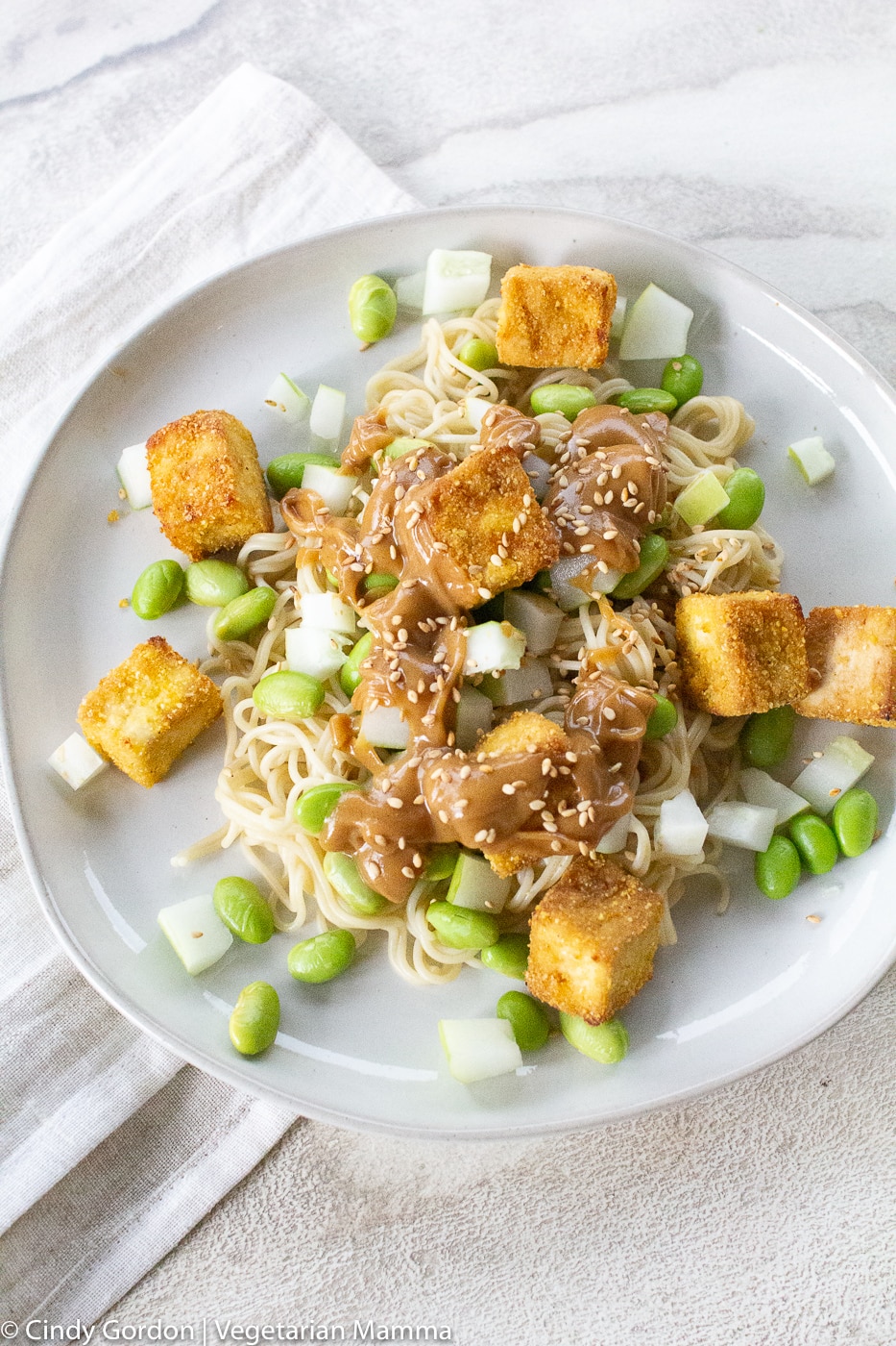 Tofu Noodle Bowl plated on a white plate with a white napkin