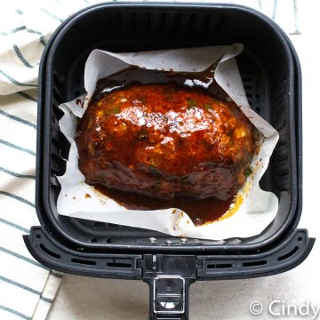 Air Fryer Meatloaf in air fryer baskets with a beautiful deep marroon glaze on top