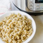 a bowl of brown rice sitting beside an Instant Pot