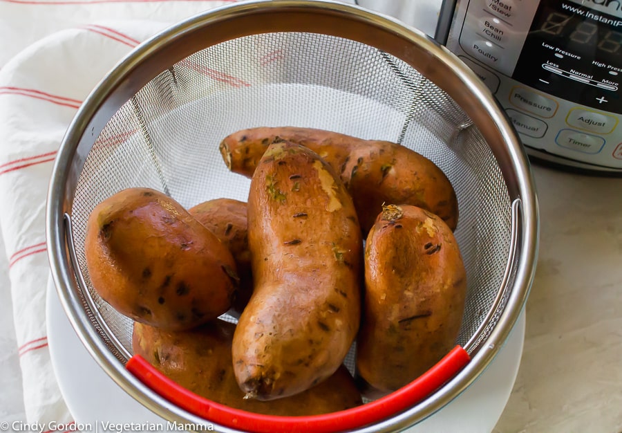 sweet potatoes in a colander beside an instant pot