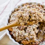 closeup of a wooden spoon with vegan apple crisp