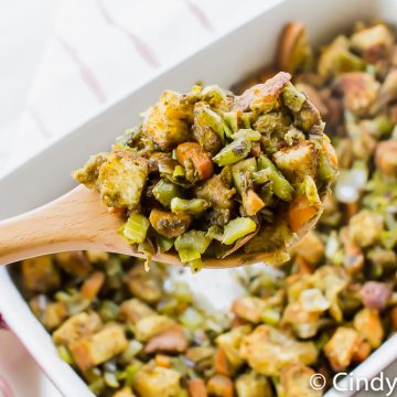 a spoonful of stuffing over a baking dish filled with stuffing