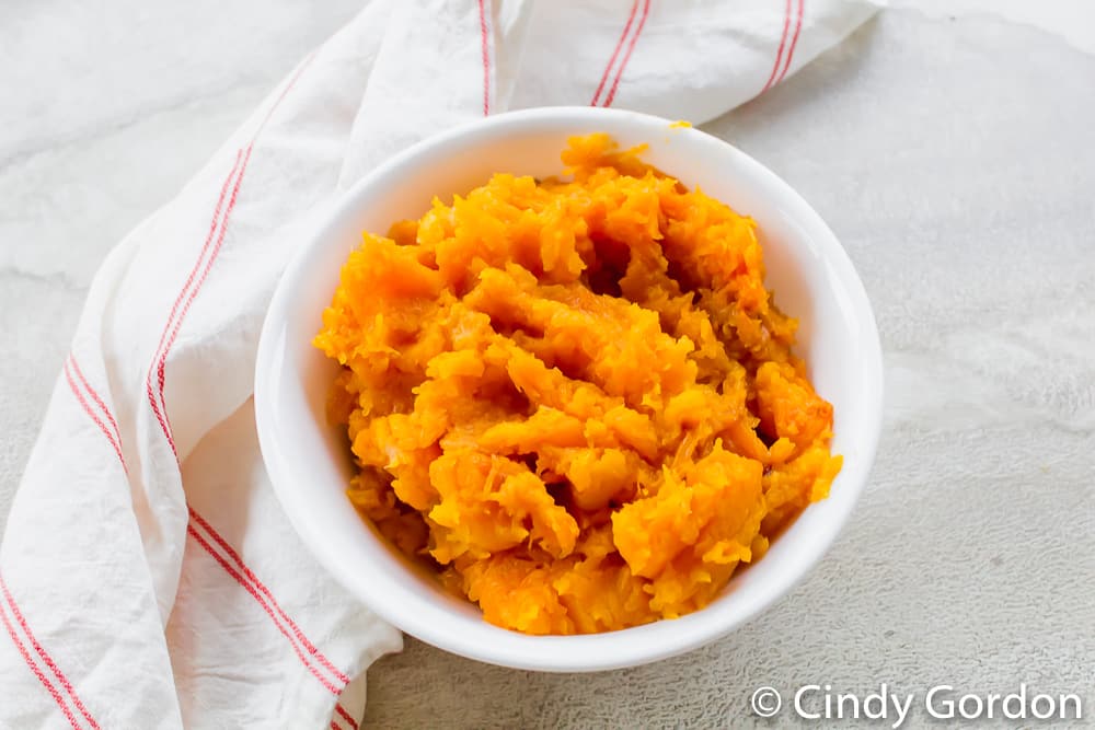 roasted and mashed butternut squash in a white bowl