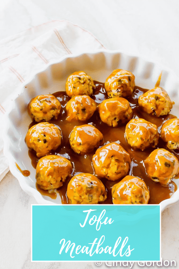Vegan Meatballs are glazed in a sweet sauce and perfect for parties! These tofu "meatballs" are packed with red onion, parsley, oregano, and a little liquid smoke and baked for half an hour for a tender and delicious vegetarian appetizer. #tofumeatballs #appetizer #vegan