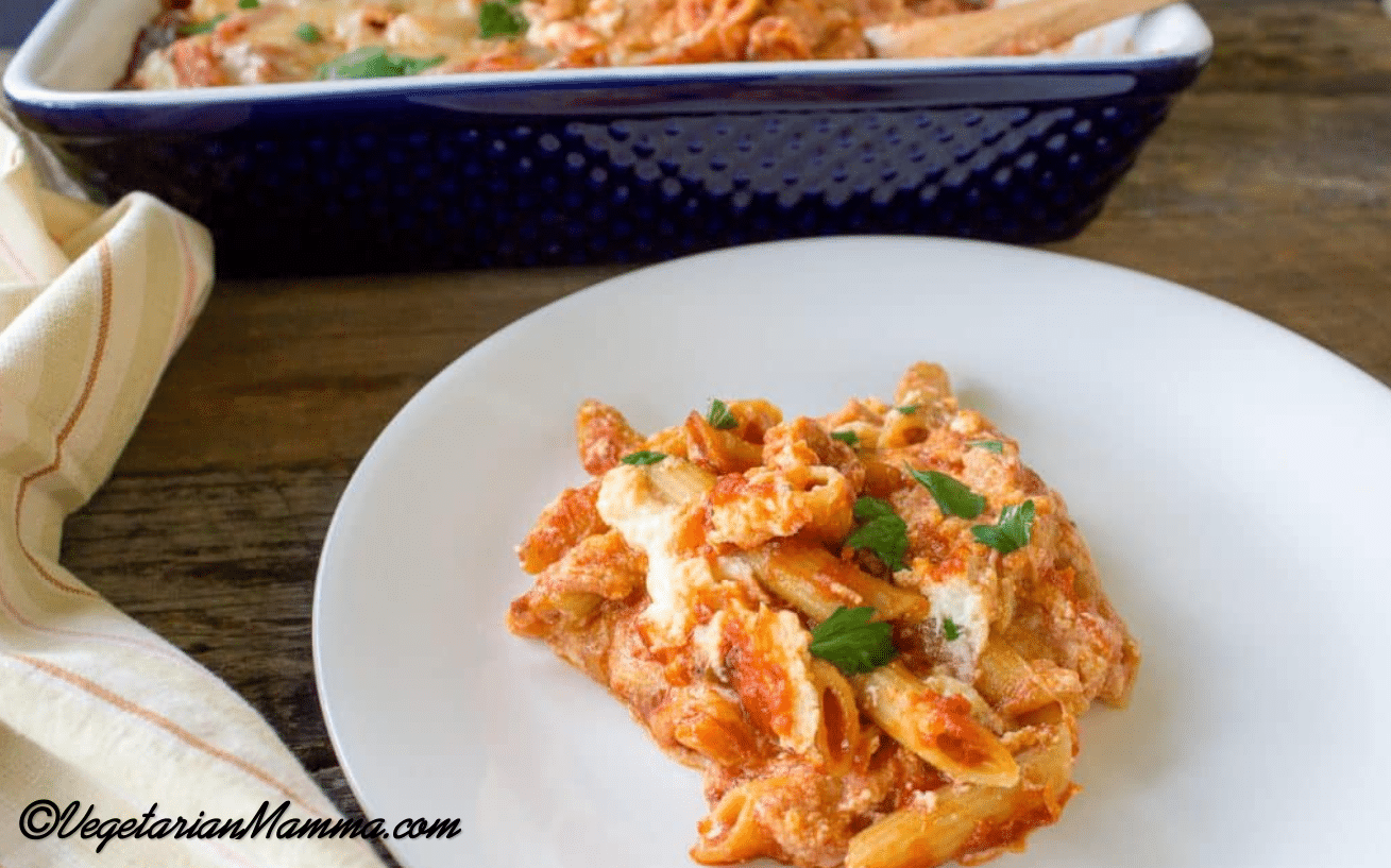 A white plate full of deconstructed lasagna.