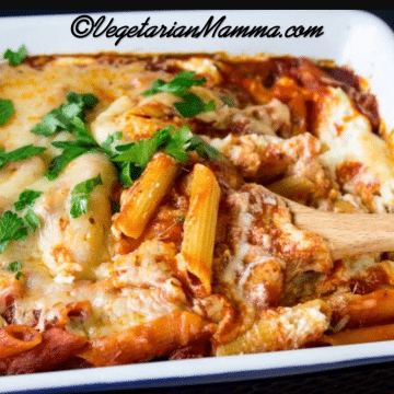 A white pan filled with cheese, sauce, and noodles.