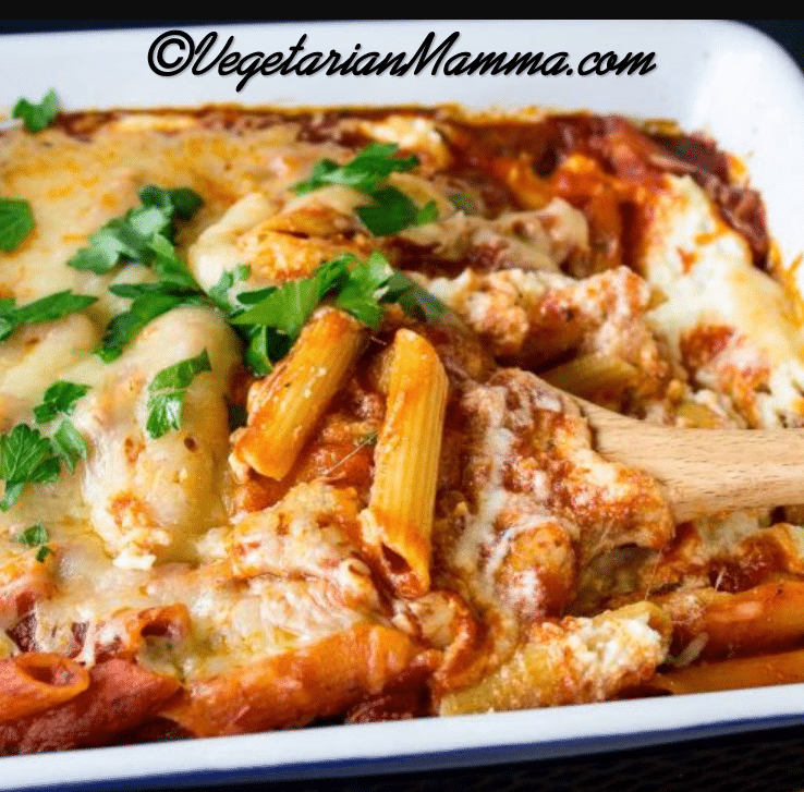 A white pan filled with cheese, sauce, and noodles.