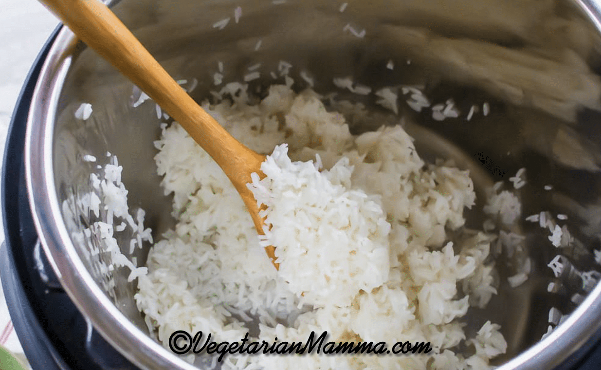 Jasmine rice on a wooden spoon in an Instant Pot