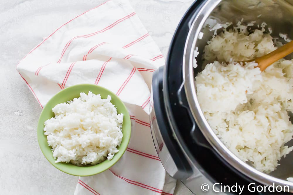 A bowl of jasmine rice next to an Instant Pot of rice
