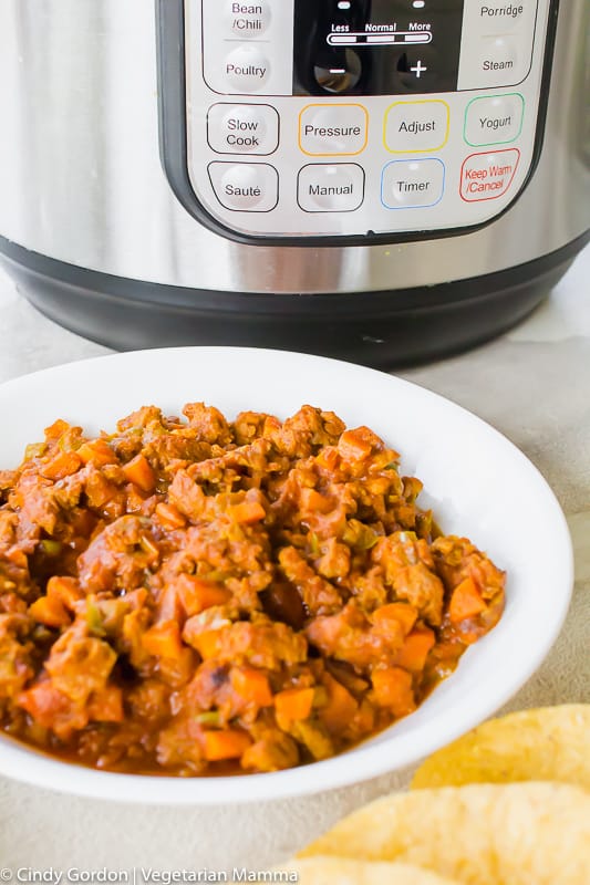 A white bowl of vegetarian taco "meat" in front of an Instant Pot