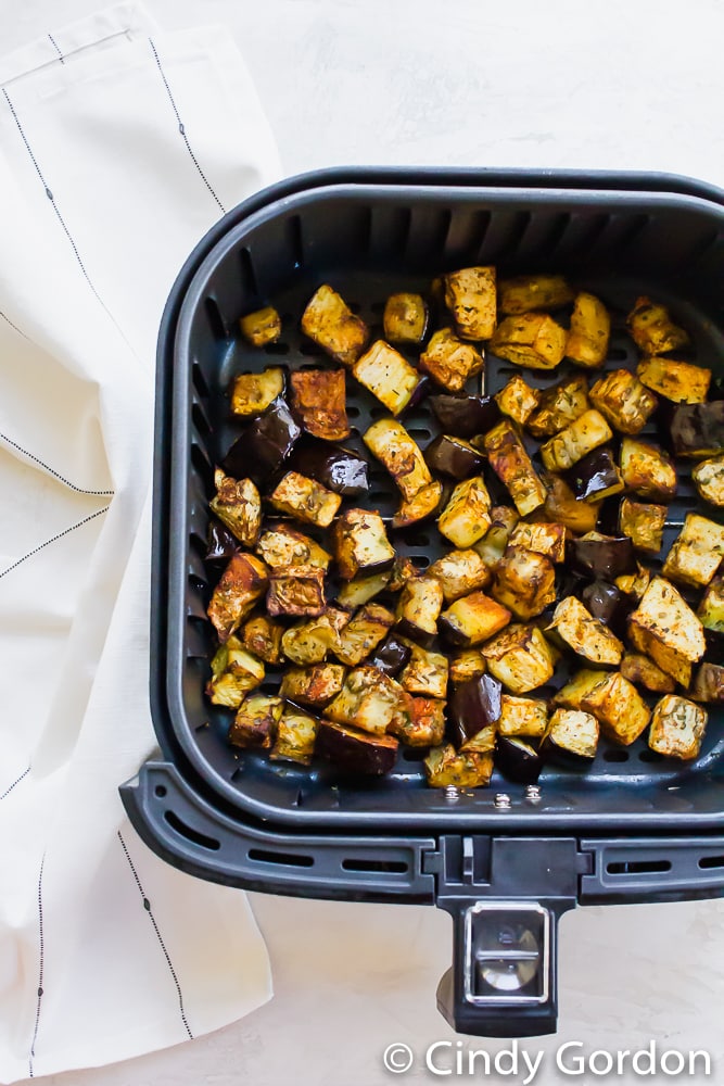 cubed eggplant in black air fryer basket