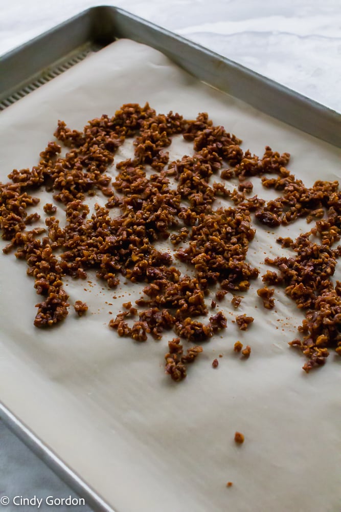 Piles of meatless bacon bits on a baking sheet with parchment paper