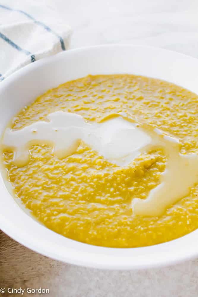 Close-up of yellow corn grits with melted butter and nutritional yeast