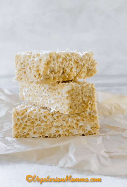 A stack of three vegan rice Krispie treats on parchment paper