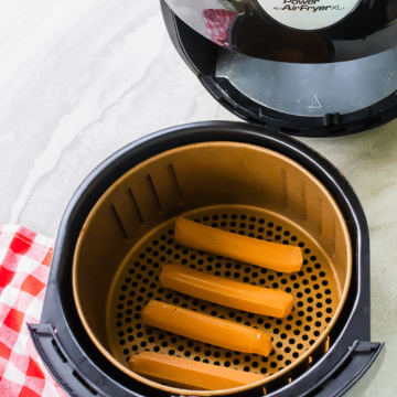 air fryer hot dogs in basket before cooking