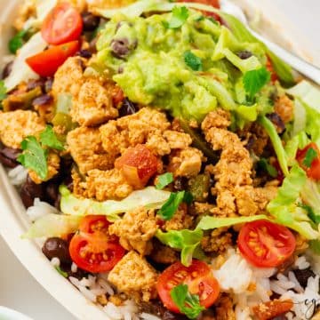 Sofritas in a bowl with lettuce, tomatoes and guac