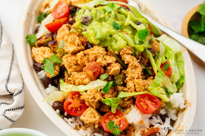 Sofritas in a bowl with lettuce, tomatoes and guac