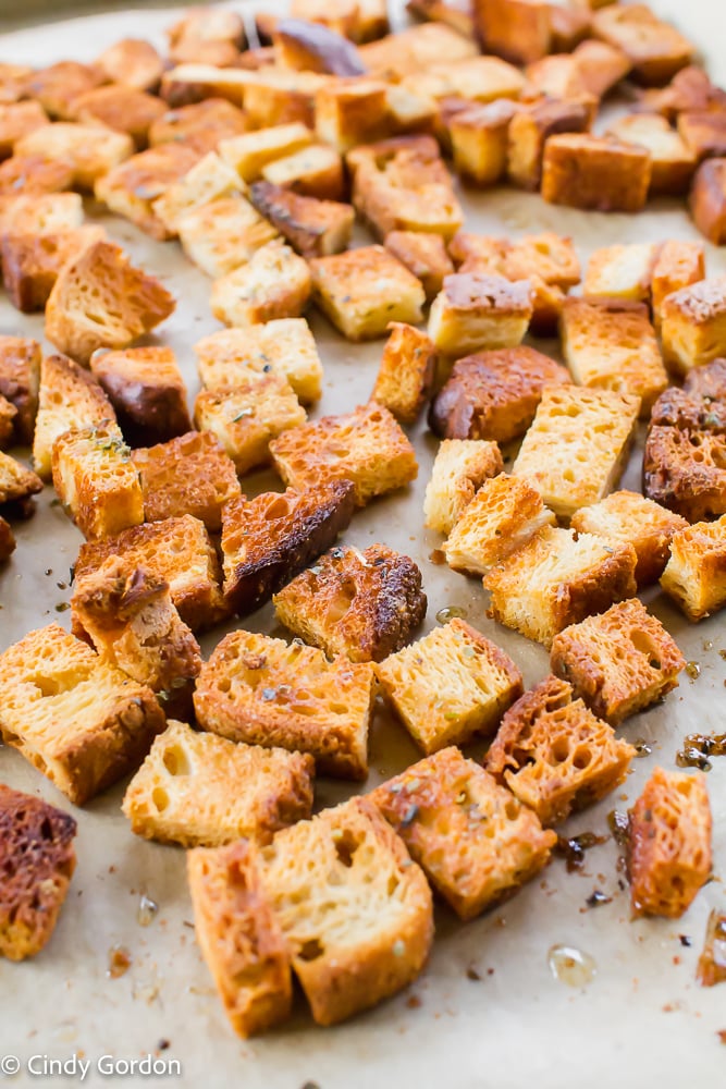 Close-up shot of seasoned vegan croutons on parchment paper