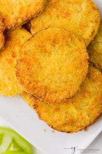 golden brown bread air fryer fried green tomatoes on a white plate