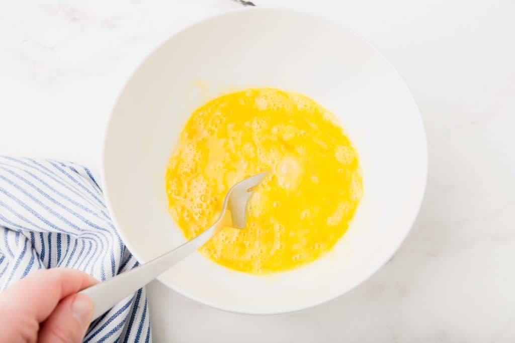 white bowl with whisked egg