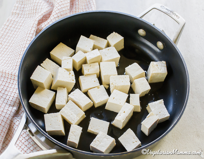 Cut the tofu into bite-sized pieces. Sauté it in a skillet with sesame oil over medium heat for about 10 minutes, flipping occasionally.