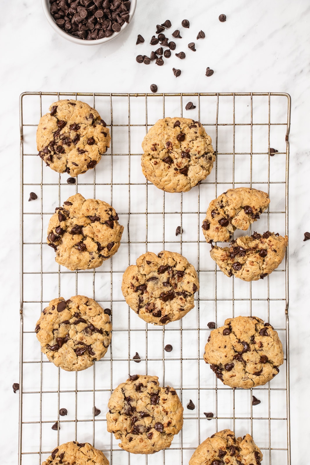 Chewy vegan oatmeal chocolate chip cookies cooling on a wire rack