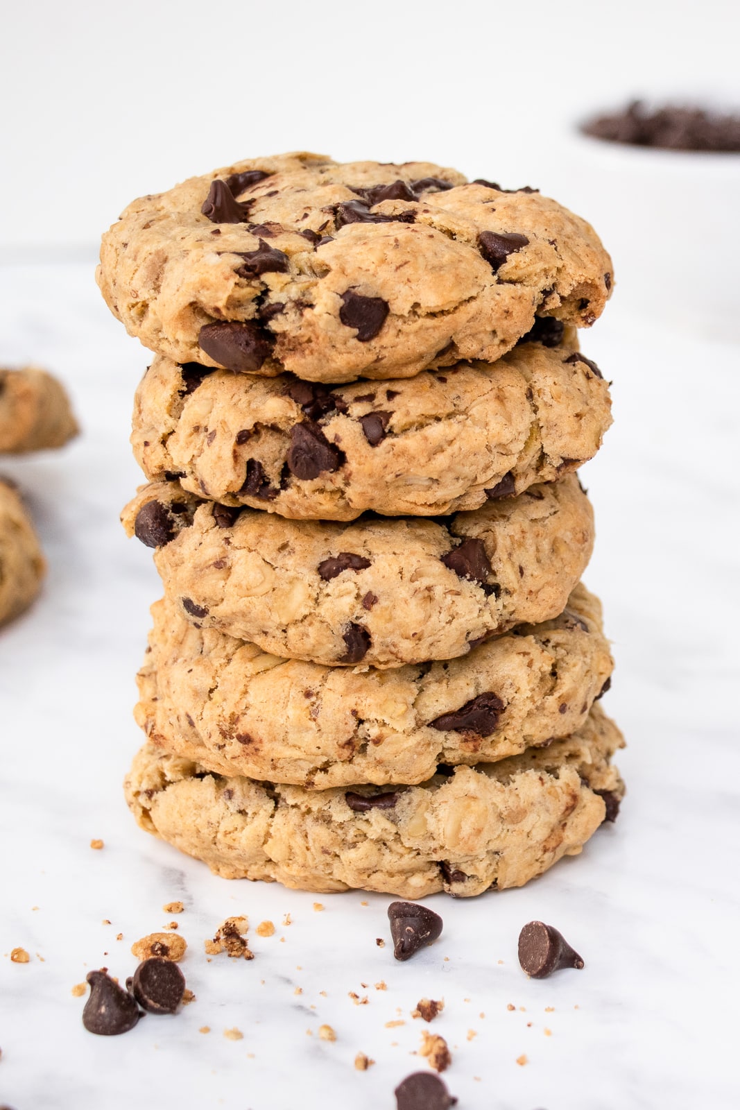 Close-up shot of a stack of 5 thick oatmeal chocolate chip cookies