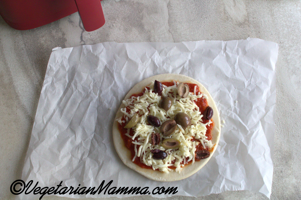 pita with sauce, cheese, and olives