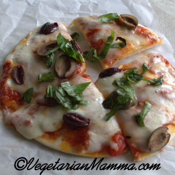 air fryer pizza cut into four pieces. The base is from pita bread.