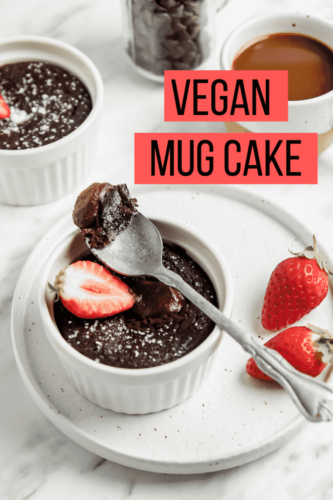 A bite of vegan chocolate mug cake over the ramekin of cake with overlay text