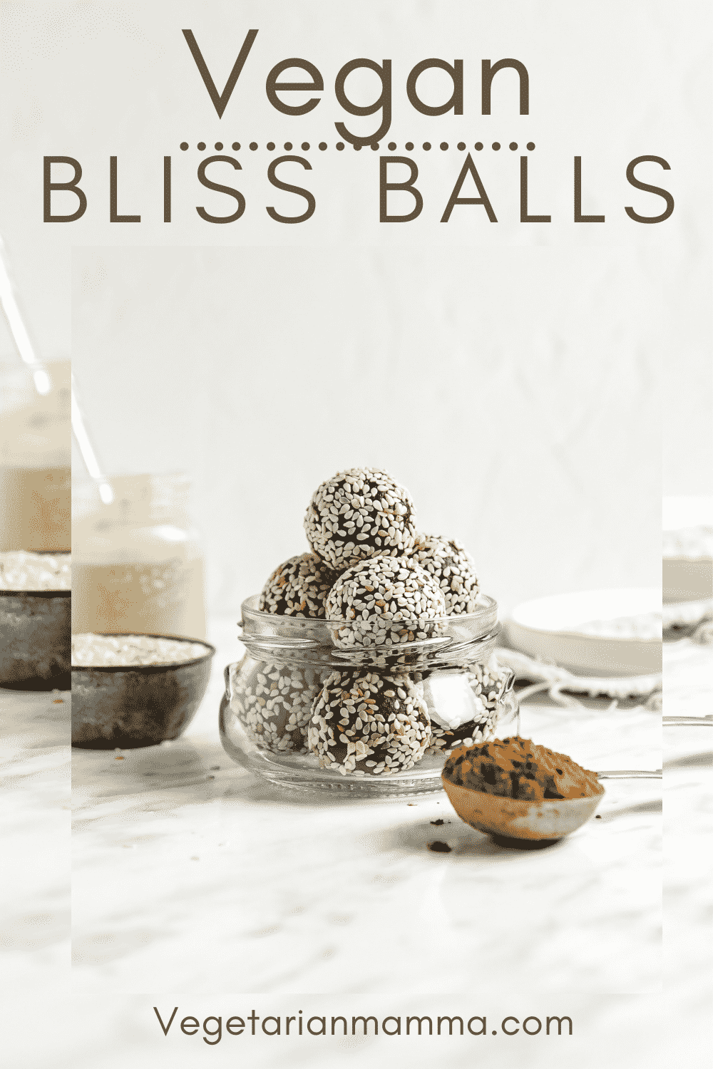 Bliss Balls are so decadent you'll forget they're healthy, too! These vegan chocolate tahini balls are covered in sesame seeds for the best no-bake dessert, afternoon snack, or even breakfast on-the-go. #vegansnack #energyballs