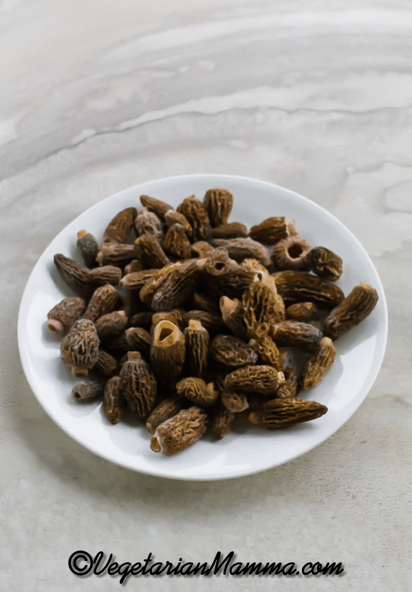 Raw Morel Mushrooms on a white plate