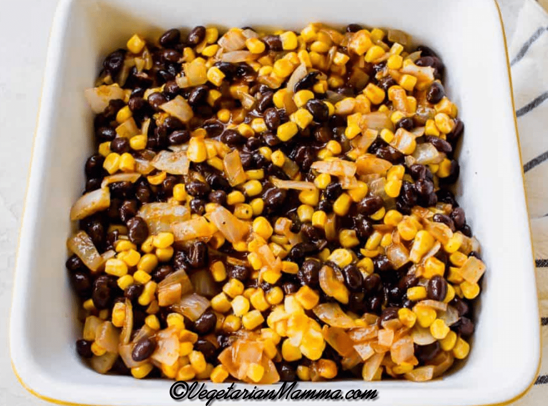 black bean, corn, and onion mixture on top of tater tots in casserole