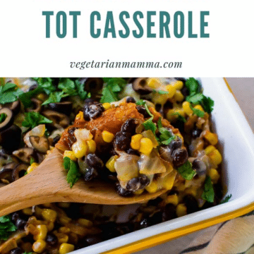 A white pan of Mexican tator tot casserole with a spoon full of the casserole.