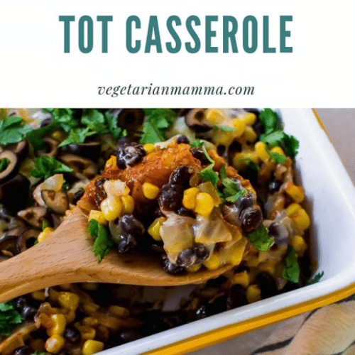 A white pan of Mexican tator tot casserole with a spoon full of the casserole.